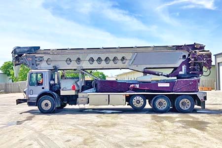 Very low mileage and hours twin-steer conveyor truck in nearly new condition.